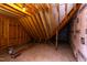 Unfinished attic with wooden beams and insulation at 75 Harvest View Way, Franklinton, NC 27525