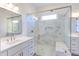 Well-lit bathroom with a marble walk-in shower, double vanity, and elegant gold fixtures at 75 Harvest View Way, Franklinton, NC 27525