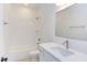 Modern bathroom featuring a tub and shower, white subway tile, a vanity with sink, and a large mirror at 75 Harvest View Way, Franklinton, NC 27525