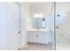 Bright bathroom featuring a marble tiled shower with glass enclosure, vanity with gold hardware, and linen closet at 75 Harvest View Way, Franklinton, NC 27525