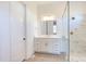 Bright bathroom featuring a marble tiled shower with glass enclosure, vanity with gold hardware, and linen closet at 75 Harvest View Way, Franklinton, NC 27525