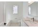 Bathroom with tiled floors, a shower/tub combo, single vanity with granite counters, and bright natural light at 75 Harvest View Way, Franklinton, NC 27525
