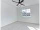 Bedroom featuring plush carpet, a modern ceiling fan, a large window, and freshly painted walls at 75 Harvest View Way, Franklinton, NC 27525