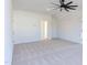 Large bedroom with plush carpet and ample natural light from large windows and a modern ceiling fan at 75 Harvest View Way, Franklinton, NC 27525