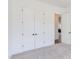 Neutral bedroom with plush carpeting, closet doors and a doorway leading to another room at 75 Harvest View Way, Franklinton, NC 27525