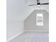 Attic bedroom with a sloped ceiling, neutral carpet, bright window, and modern ceiling fan at 75 Harvest View Way, Franklinton, NC 27525