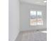 Bright, carpeted bedroom space featuring a large window showcasing a nature view at 75 Harvest View Way, Franklinton, NC 27525