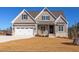 Charming single-Gathering home with a two-car garage and craftsman-style details on a sunny day at 75 Harvest View Way, Franklinton, NC 27525