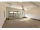 Spacious two-car garage with concrete floors and a roll-up door at 75 Harvest View Way, Franklinton, NC 27525