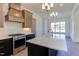 Bright kitchen features stainless steel appliances, a large island, and a stylish vent hood at 75 Harvest View Way, Franklinton, NC 27525