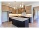 Modern kitchen with an island, white countertops, stainless steel appliances, and custom cabinets at 75 Harvest View Way, Franklinton, NC 27525