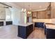 Kitchen featuring an island, granite countertops, stainless appliances, and a nearby fireplace at 75 Harvest View Way, Franklinton, NC 27525