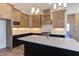 Modern kitchen with an island, white countertops, stainless steel appliances, and custom cabinets at 75 Harvest View Way, Franklinton, NC 27525