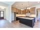 Modern kitchen with an island, white countertops, stainless steel appliances, and custom cabinets at 75 Harvest View Way, Franklinton, NC 27525