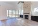 Bright living room with a stone fireplace, built-in cabinets, and sliding glass doors leading to a porch at 75 Harvest View Way, Franklinton, NC 27525
