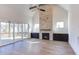 Bright living room with a stone fireplace, built-in cabinets, and sliding glass doors leading to a porch at 75 Harvest View Way, Franklinton, NC 27525
