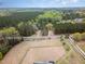 Overhead view of a property featuring a home, extensive acreage, and surrounding mature trees and farmland at 7722 Nc 27 W, Lillington, NC 27546
