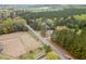 An aerial view of a sprawling wooded property with updated homes and land at 7722 Nc 27 W, Lillington, NC 27546