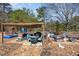 Backyard patio under canopy with seating, a grill, and a pool for hot summer days at 7722 Nc 27 W, Lillington, NC 27546