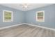 Comfortable and airy bedroom with two bright windows and modern flooring at 7722 Nc 27 W, Lillington, NC 27546