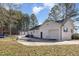 A sprawling white brick home with garage, large driveway, and a big backyard at 7722 Nc 27 W, Lillington, NC 27546
