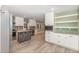 Bright kitchen features white cabinets, granite counters, and a functional center island at 7722 Nc 27 W, Lillington, NC 27546