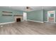 Spacious living room featuring stylish gray wood flooring, ceiling fan and calming light green walls at 7722 Nc 27 W, Lillington, NC 27546