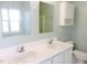 Bright bathroom featuring a double sink vanity, mirror and storage, with natural light from a window at 8 Weeping Beech Way, Durham, NC 27713
