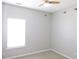 This bedroom features a ceiling fan, neutral carpet and light coming from a window at 8 Weeping Beech Way, Durham, NC 27713