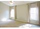 Bright bedroom featuring neutral walls, carpeting and large windows with stylish curtains at 8 Weeping Beech Way, Durham, NC 27713