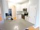 Bright kitchen featuring white cabinets, stainless steel appliances and a breakfast bar with seating at 8 Weeping Beech Way, Durham, NC 27713