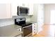 Well-equipped kitchen with stainless steel appliances and white cabinetry at 8 Weeping Beech Way, Durham, NC 27713