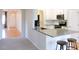 Well-lit kitchen featuring a breakfast bar with seating, white cabinets, and stainless steel appliances at 8 Weeping Beech Way, Durham, NC 27713