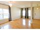 Spacious living room with hardwood floors, a modern chandelier, and bright natural light at 8 Weeping Beech Way, Durham, NC 27713