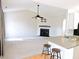 Open living room with fireplace, ceiling fan and a view of the kitchen with breakfast bar at 8 Weeping Beech Way, Durham, NC 27713