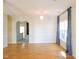 Open-concept living space with wood floors, large windows, and elegant chandelier at 8 Weeping Beech Way, Durham, NC 27713