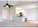 Open living room featuring a view of the kitchen breakfast bar with white cabinets and stainless appliances at 8 Weeping Beech Way, Durham, NC 27713