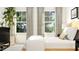 Bright bedroom featuring large windows with elegant neutral curtains at 917 Thimbleweed Way, Wake Forest, NC 27587