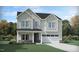 Charming two-story home featuring a two car garage, stone accents, and meticulous landscaping at 917 Thimbleweed Way, Wake Forest, NC 27587
