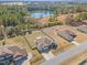 Aerial view of the property showing the house, yard, and surrounding trees and pond at 99 Preserve Dr, Benson, NC 27504