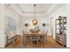 Bright dining room featuring hardwood floors, a tray ceiling, and a charming decor at 99 Preserve Dr, Benson, NC 27504