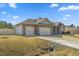 Beautiful single Gathering home showcasing brick and gray siding, manicured lawn, and 3 car garage at 99 Preserve Dr, Benson, NC 27504