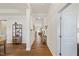 Spacious hallway with hardwood floors, decorative shelving, and elegant trim detail at 99 Preserve Dr, Benson, NC 27504
