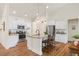 Bright kitchen boasts white cabinets, stainless steel appliances, and granite countertops at 99 Preserve Dr, Benson, NC 27504