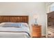 Bedroom view of bed with wooden headboard, lamps, and window with natural lighting at 99 Preserve Dr, Benson, NC 27504