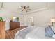 Spacious main bedroom features a ceiling fan, tv, and view into the ensuite bathroom at 99 Preserve Dr, Benson, NC 27504