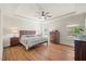 Relaxing main bedroom offers a tray ceiling, ceiling fan, and hardwood floors at 99 Preserve Dr, Benson, NC 27504