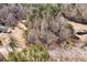 An aerial view of the property showcases dense trees and a long, winding paved driveway at 10611 Quail Roost Rd, Bahama, NC 27503