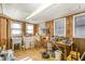 Multipurpose basement space with tile flooring, wood paneling, and large windows for natural light at 10611 Quail Roost Rd, Bahama, NC 27503