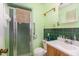 Bathroom with a shower and wood cabinets at 10611 Quail Roost Rd, Bahama, NC 27503